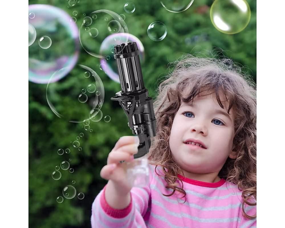 Child playing with 8 hole bubble gun toy for kids with batteries creating many bubbles outdoors