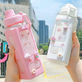 Cute straw water bottle for boys & girls in pink and white with cartoon animal designs and decorative charms