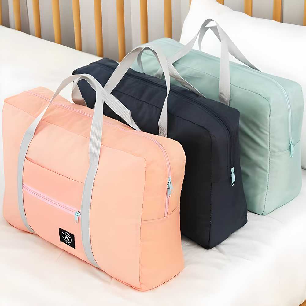 Set of pastel pink black and green carry on duffel bag for women with handles on bed