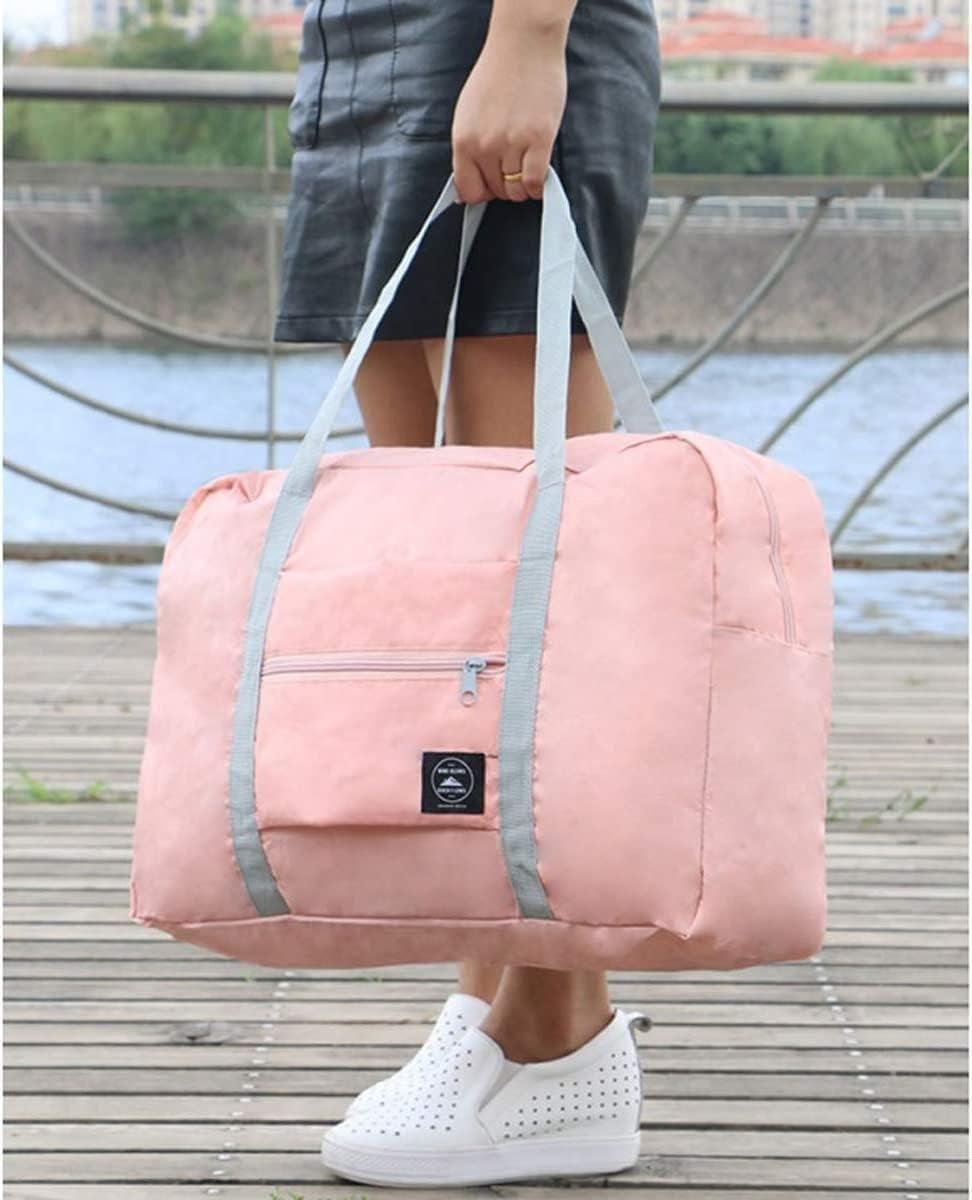 Light pink carry on duffel bag for women with gray straps held by a person wearing white perforated sneakers