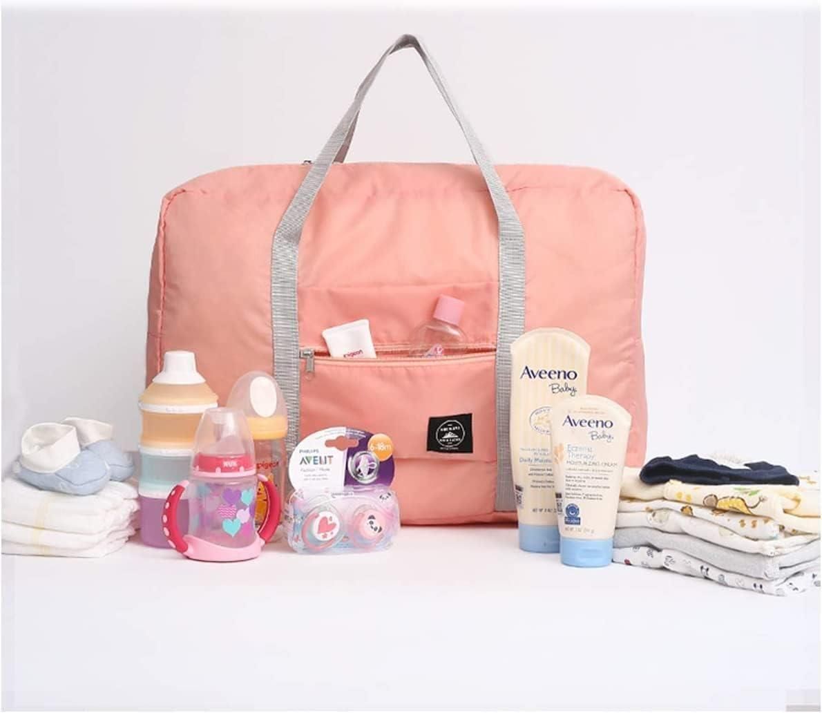 Pink carry on duffel bag for women with gray handles surrounded by baby bottles, lotion, pacifiers, and folded baby clothes