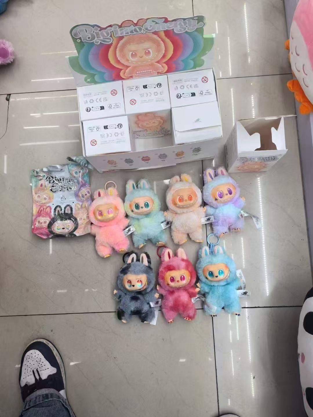 Colorful Labubu doll online India plush toys in various pastel colors displayed with packaging boxes on floor