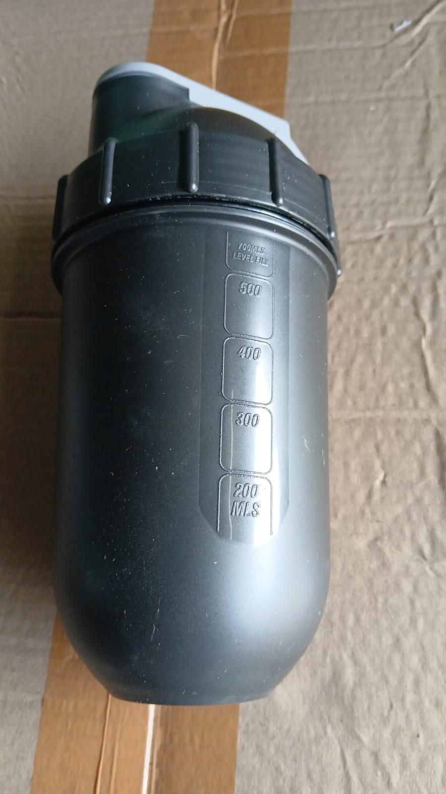 Black protein shaker bottle for gym with measurement markings up to 500 milliliters and a secure flip lid