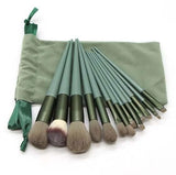 Soft bristle professional makeup brush set with green handles and a matching carrying pouch