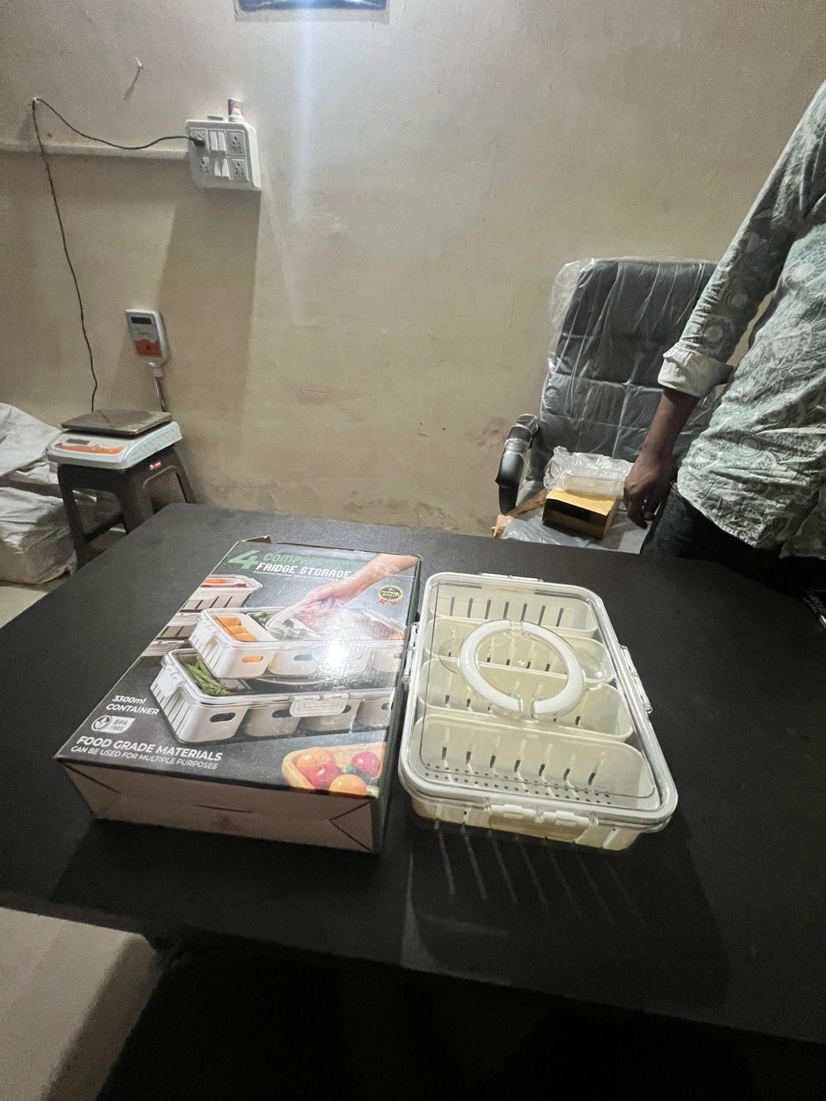 fm0kr5-at fridge storage container with multiple compartments and airtight lid on black table