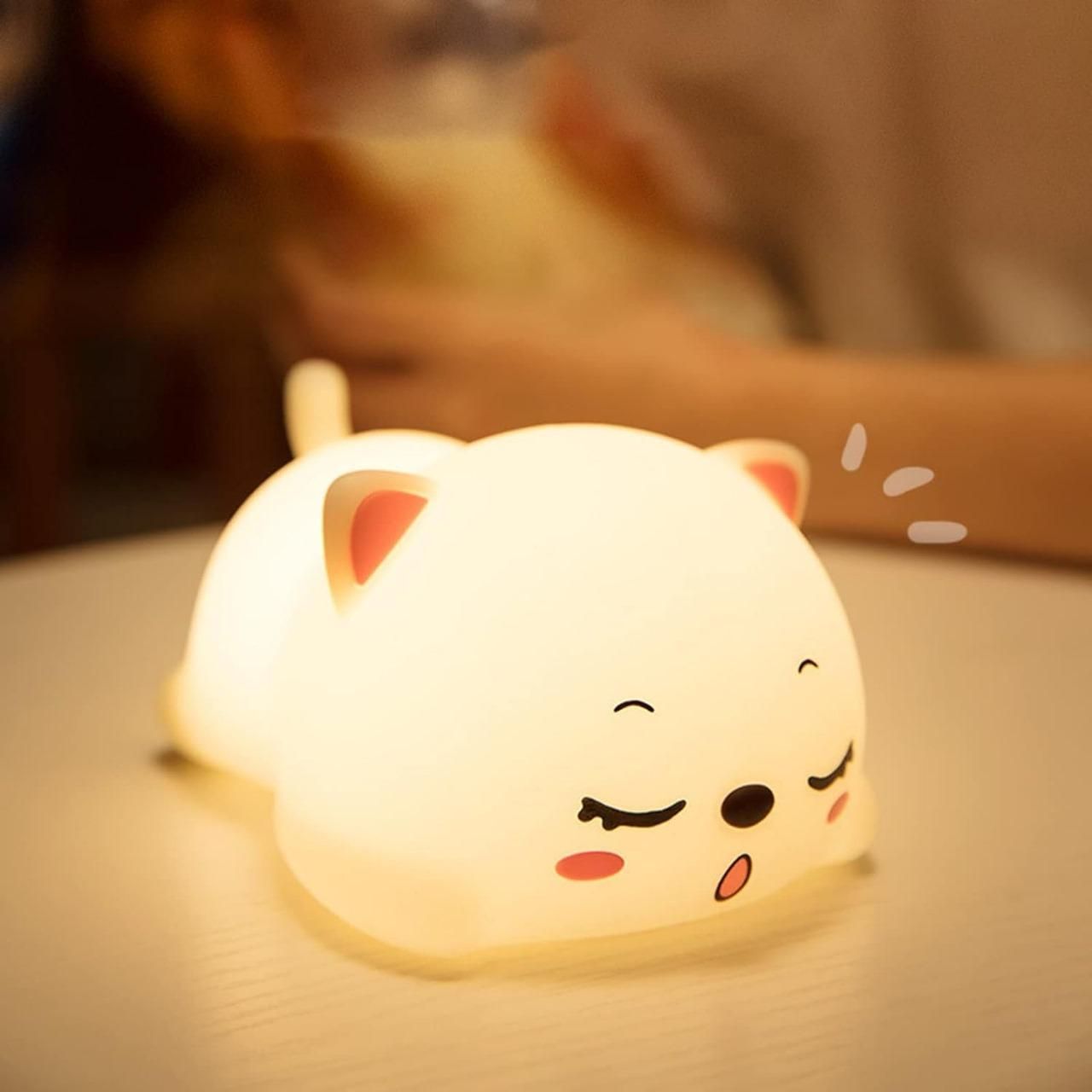 Cute silicone animal night lamp shaped like a sleeping dog glowing softly on a table