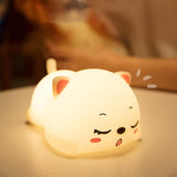 Cute silicone animal night lamp shaped like a sleeping dog glowing softly on a table