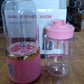 Best compact portable juicer in pink with USB charging cable and clear blending cup on wooden table