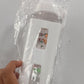 White cute straw water bottle for boys & girls with cartoon designs held in hand wrapped in plastic