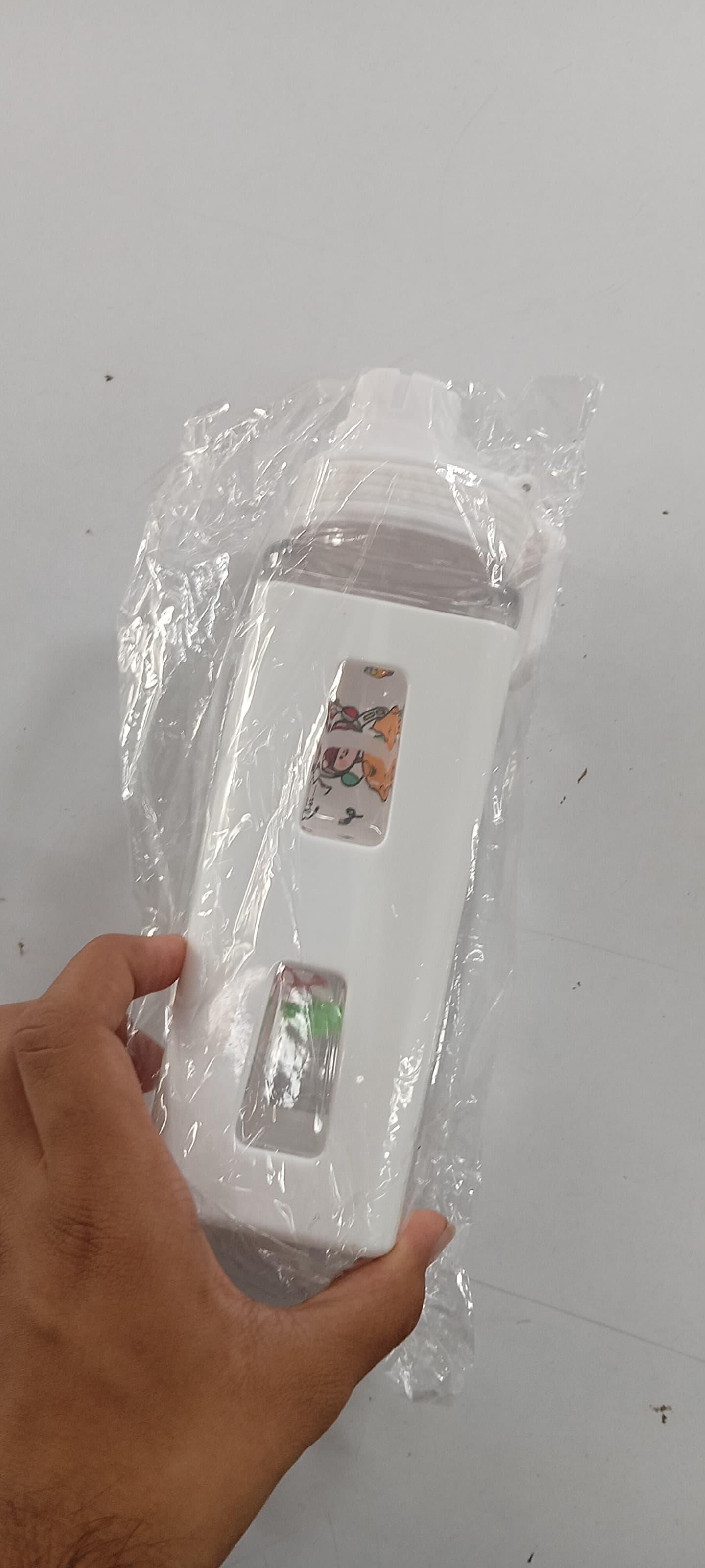 White cute straw water bottle for boys & girls with cartoon designs held in hand wrapped in plastic