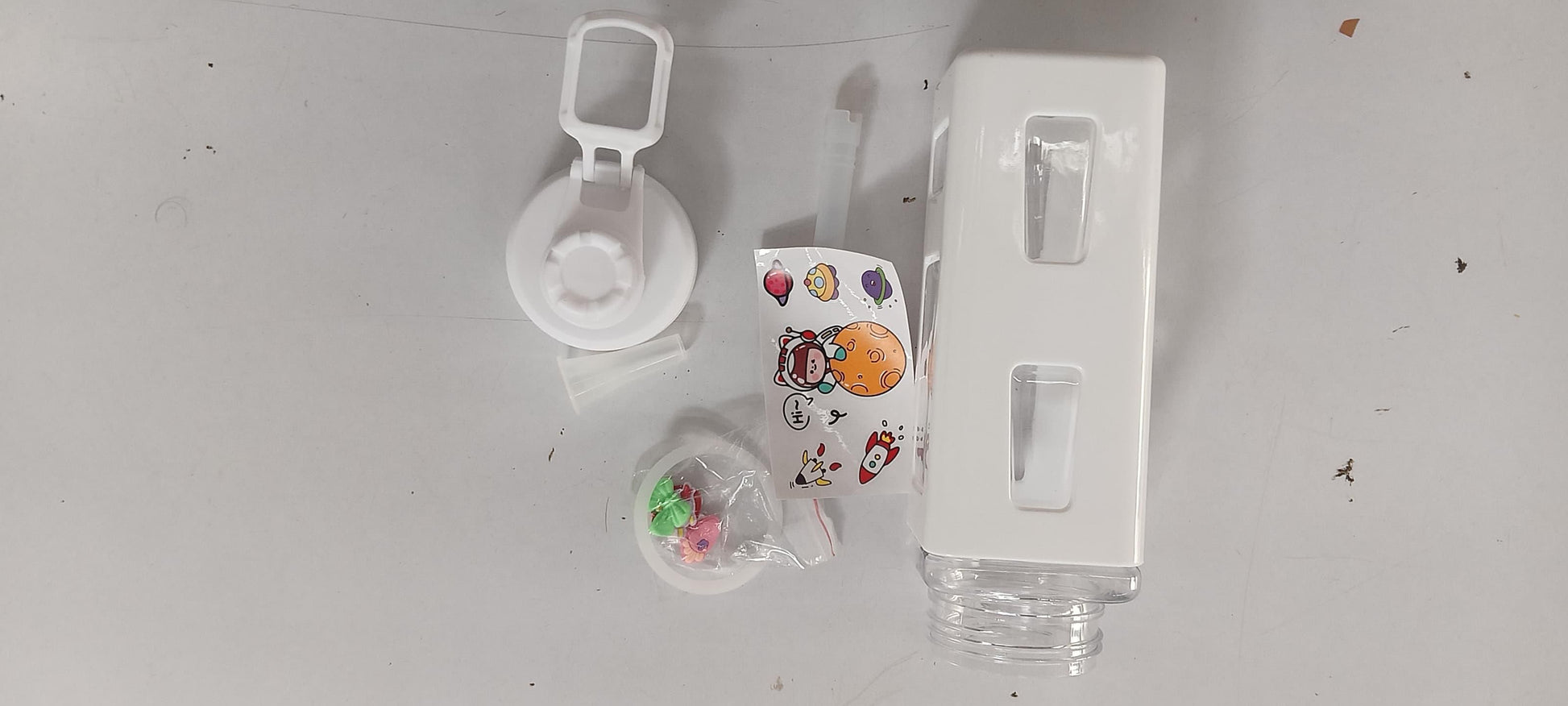 Cute straw water bottle for boys & girls with removable lid and colorful accessories on white background