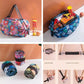 Foldable shopping bags set with colorful floral patterns shown folded and packed with groceries