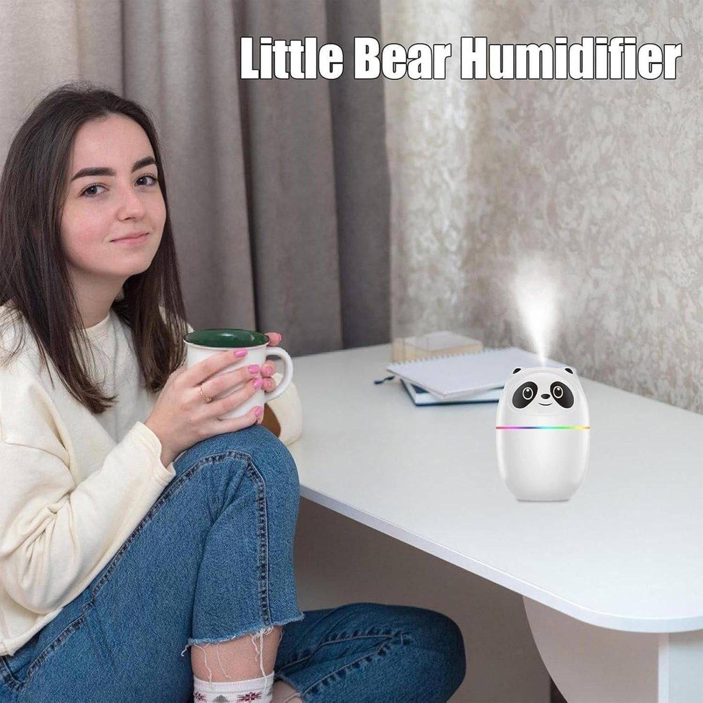 Mini cool mist humidifier for room shaped like a panda on white desk next to woman holding mug