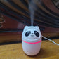 Panda-shaped mini cool mist humidifier for room emitting mist on wooden surface with cable