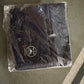 Black portable travel organizer India with zipper closure in clear plastic packaging