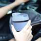 Eco friendly glass tumbler India in blue with lid held by person inside a car
